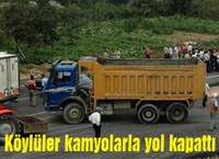 Köylüler kamyonlarla yol kapattı